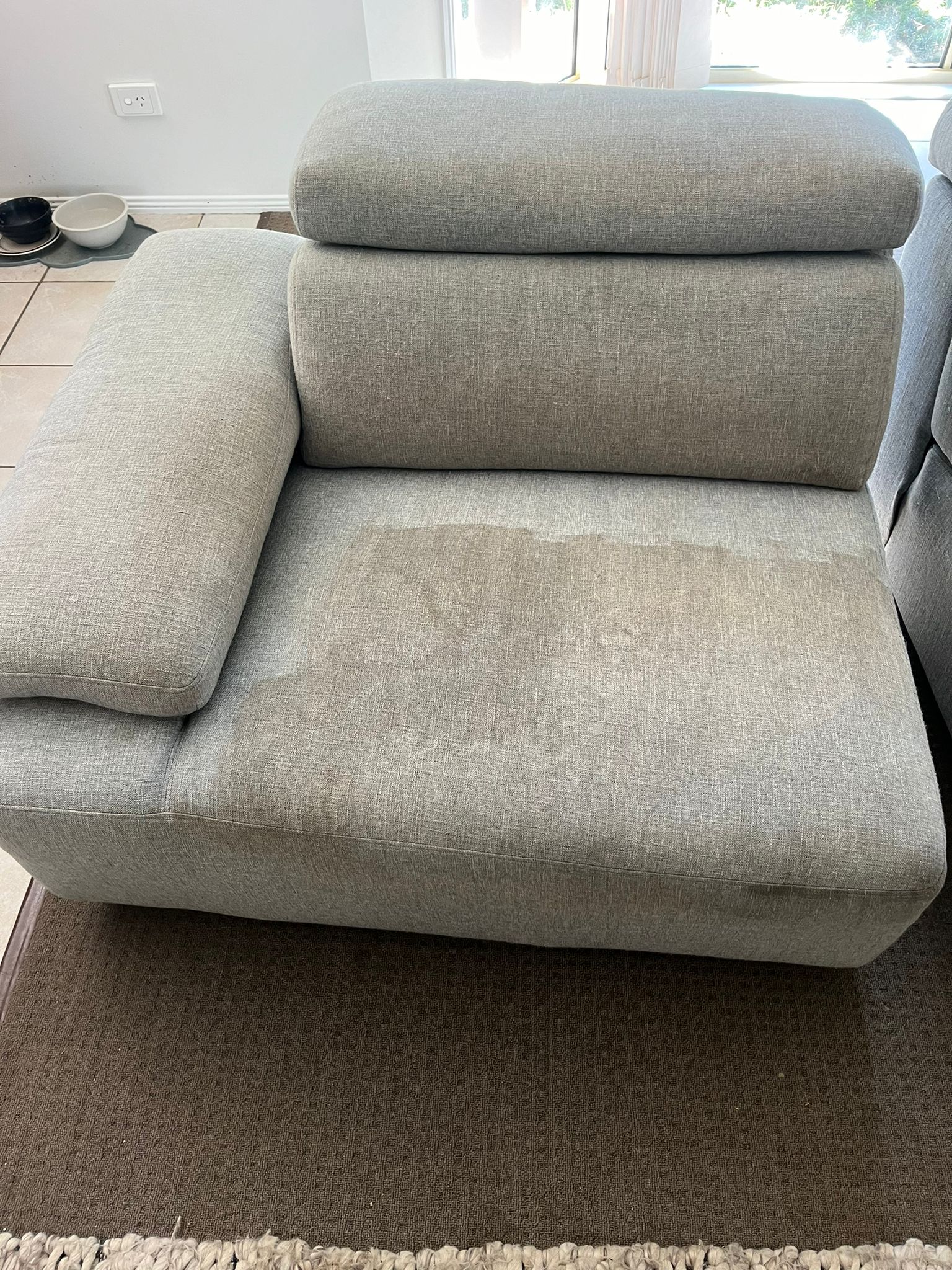 Sofa seat with stains requiring upholstery cleaning